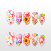 Colorful 3D floral press-on nails with sunflowers, roses, daisies, and pastel blossoms