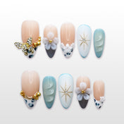 Elegant press-on nails with blue-green gradient, crystal butterfly charm, and 3D floral accents