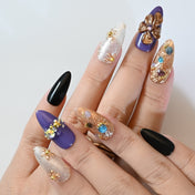 Luxury purple and gold press-on nails with textured floral design and crystal embellishments