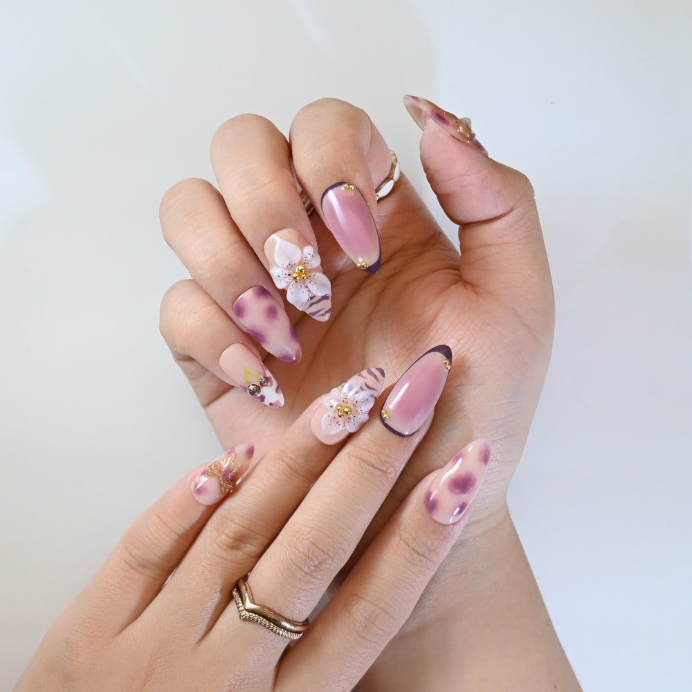 Cute girly press-on nails with leopard spots, 3D bows, cherries, and delicate flower art