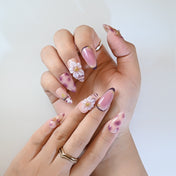 Cute girly press-on nails with leopard spots, 3D bows, cherries, and delicate flower art