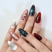 Edgy cyberpunk press-on nails with black, red, and metallic silver elements for bold style