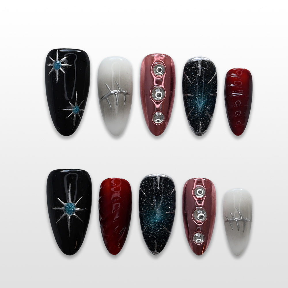 Black and red press-on nails with silver starburst, chrome accents, and galaxy glitter design
