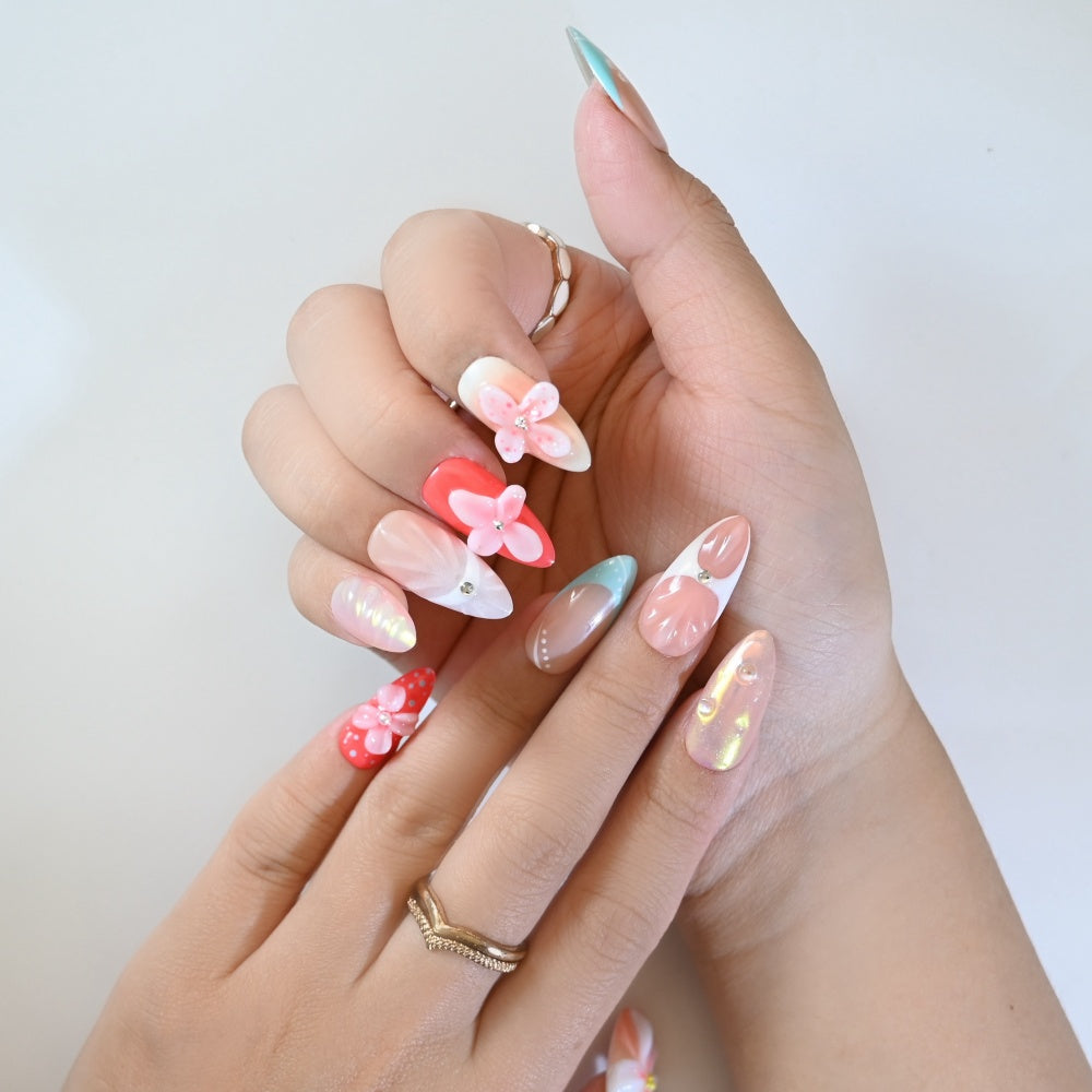 Sweet style press-on nails with pastel florals, coral accents, and shimmering iridescent finish
