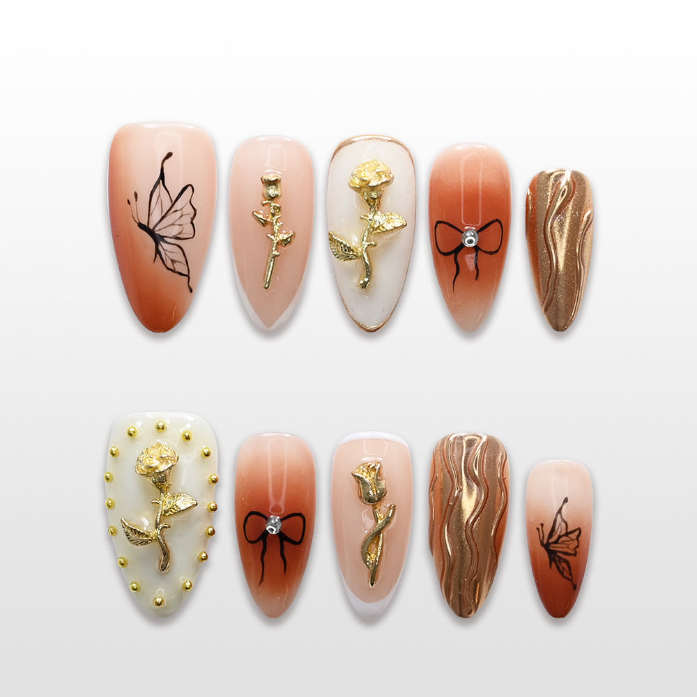 Elegant peach and gold press-on nails with 3D roses, bow design, and shimmer accents