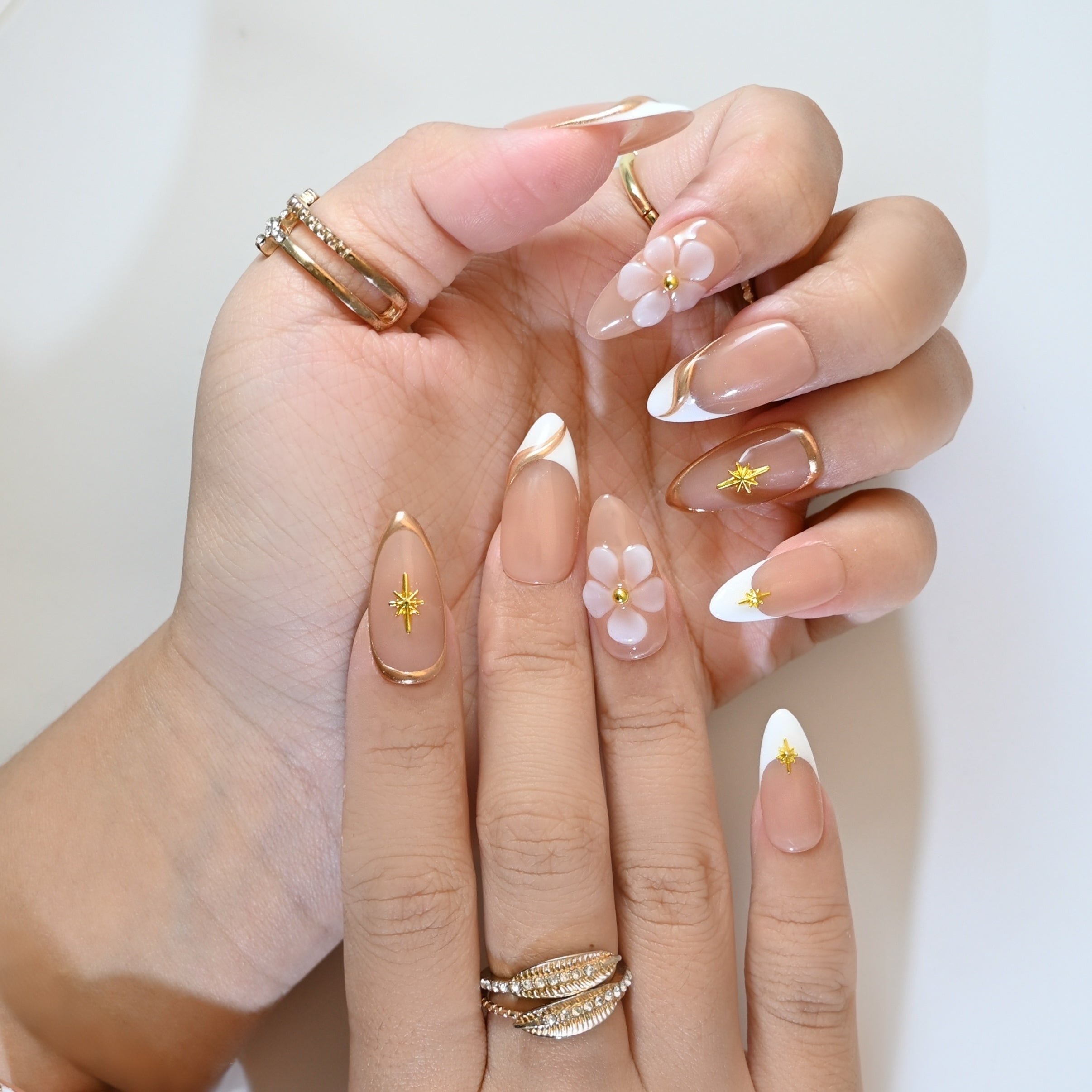 Chic French manicure style press-on nails with hand-sculpted flowers and gold accents