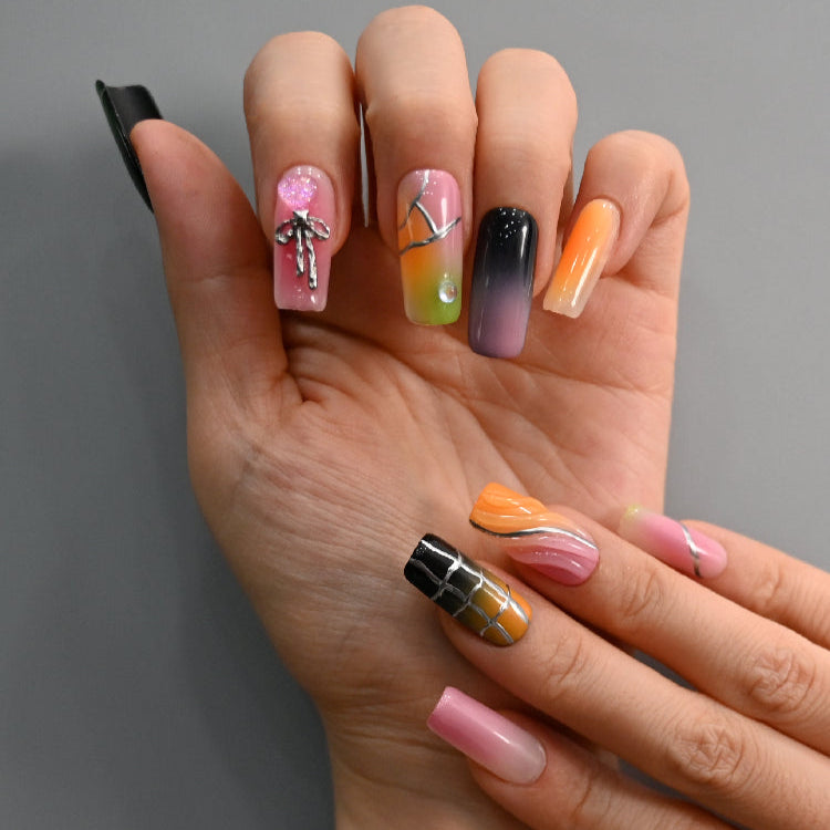 Statement press-on nails in vibrant ombre tones with chrome texture and abstract art