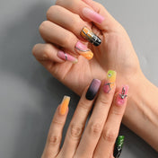 Color block ombre nails with metallic accents, heart charm, and geometric grid design