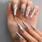 Handmade metallic nails with silver sculpted texture on a glossy white base