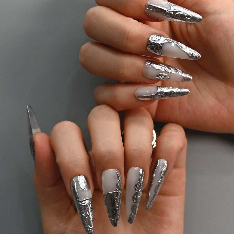 Trendy long nails with silver chrome art, sculptural texture, and glossy finish