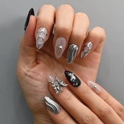 Elegant cyberpunk press-on nails with chrome wave patterns and metallic embellishments