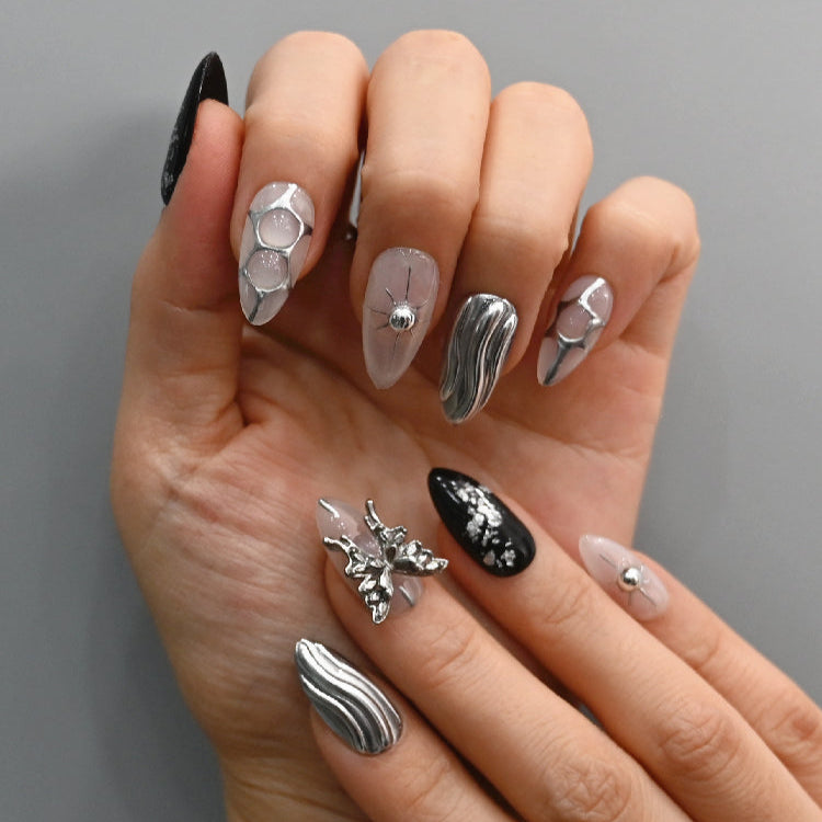 Elegant cyberpunk press-on nails with chrome wave patterns and metallic embellishments