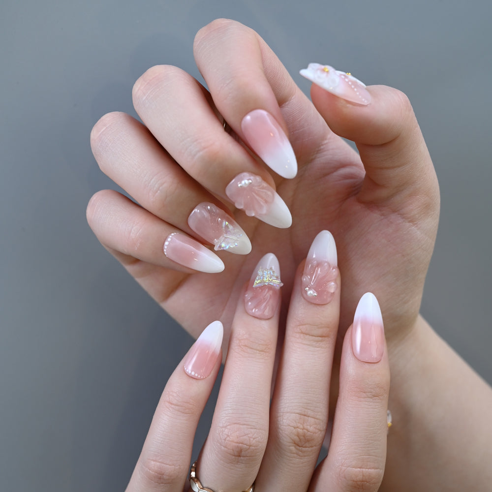 Elegant gradient press-on nails with delicate white floral accents and crystal shine
