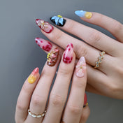 Mixed design nails with black-red ombre, yellow gradient, and floral details