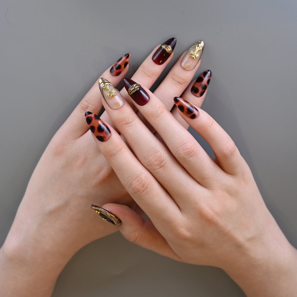 Leopard print and burgundy press-on nails with gold metallic frame accents