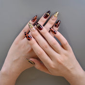 Leopard print and burgundy press-on nails with gold metallic frame accents