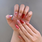 Handmade almond press-on nails with cherries, bows, and floral accents