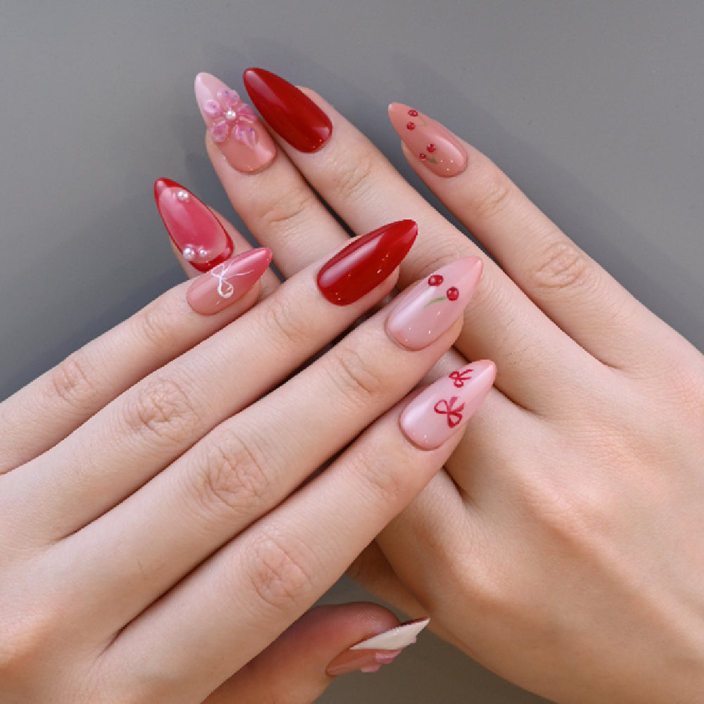 Romantic cherry-inspired nails with ribbon art and glossy finish