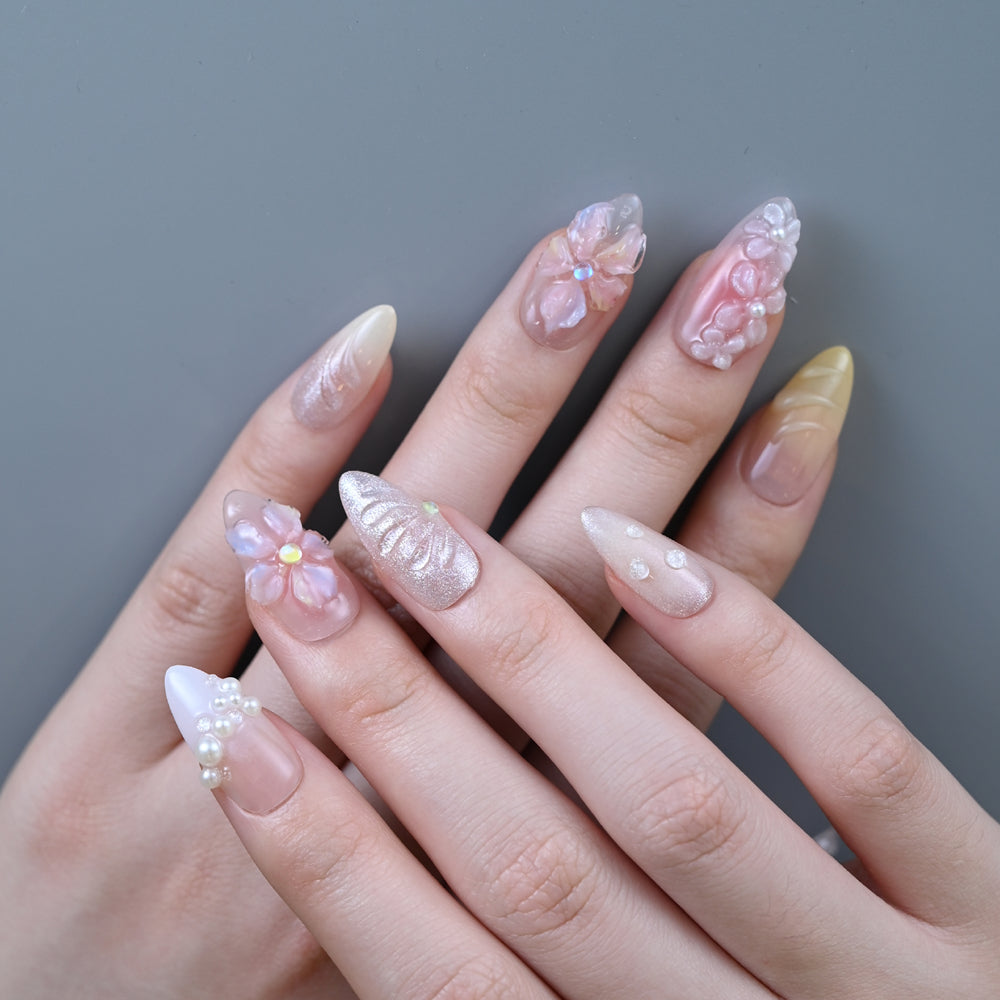 Romantic spring press-on nails in yellow, pink, and nude with floral textures