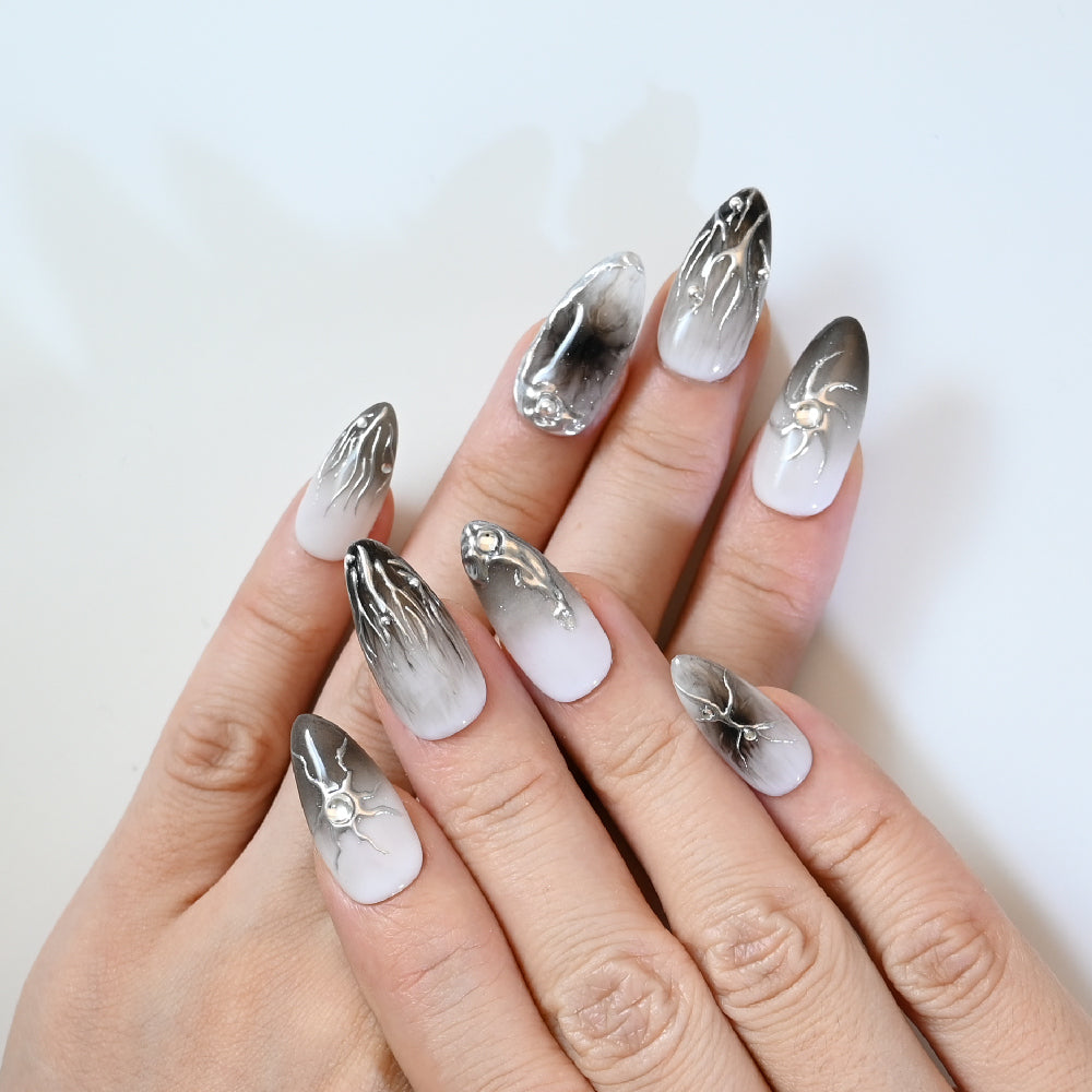 Elegant monochrome press-on nails with abstract metallic lines and ombre fade