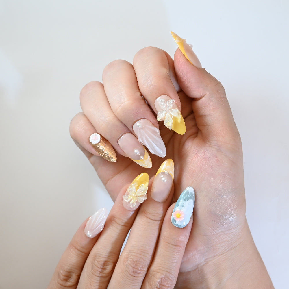 Pastel yellow and nude press-on nails with 3D flowers, pearls, and summer vibes