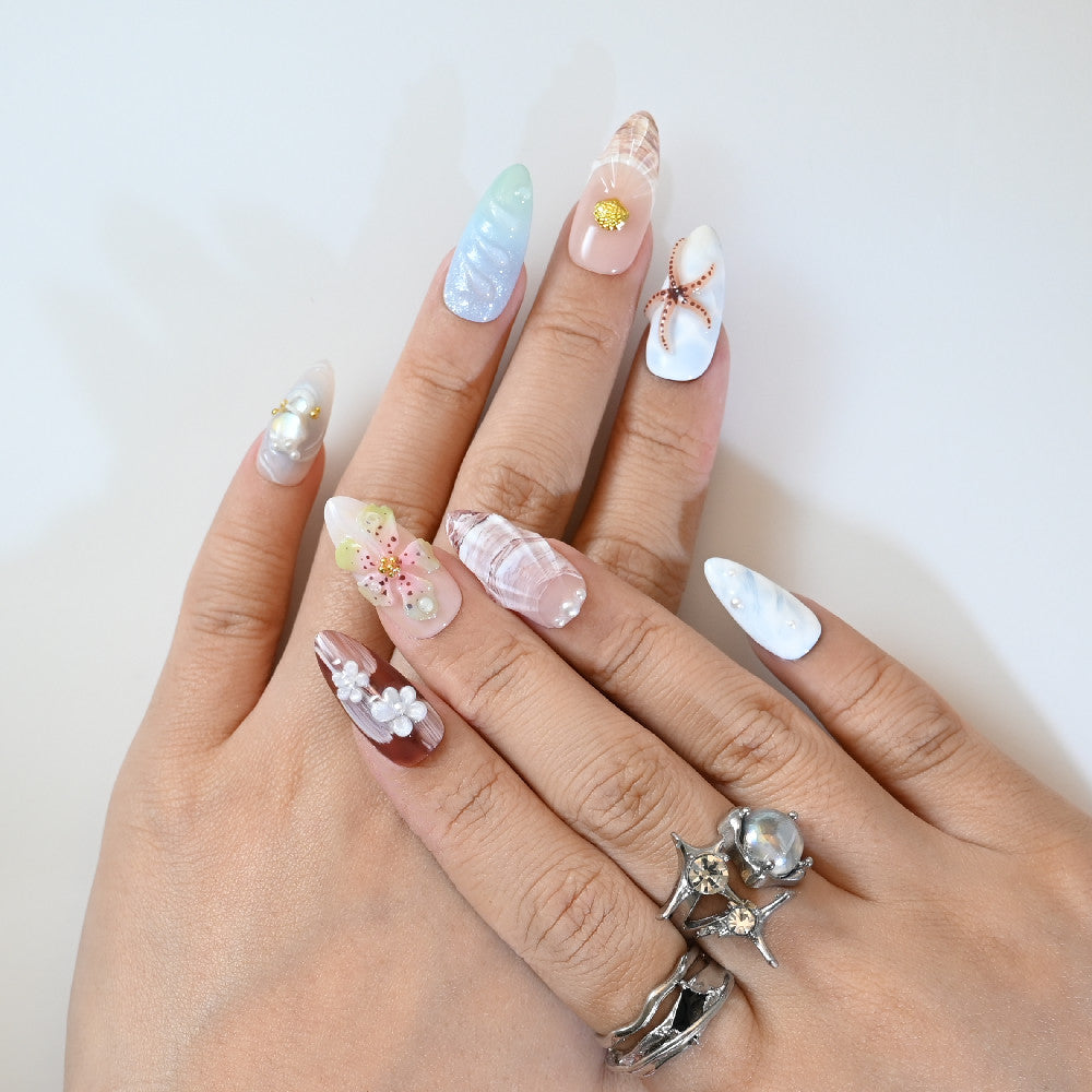 Summer coastal style press-on nails with starfish charm and beach wave patterns