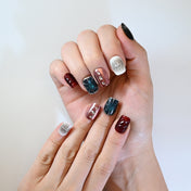 Edgy handmade nails with cosmic starburst, shimmer, and chrome studs