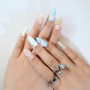 Summer seaside press-on nails with blue ombre, gold seashells, and pearl embellishments