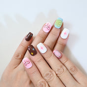 Playful press-on nails with star designs, ribbon bows, and gradient pastel backgrounds