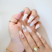 Nautical summer press-on nails with sea star, shell textures, and beach color palette