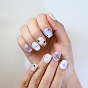 Square short press-on nails featuring dreamy lilac ombre, cosmic star accents, and 3D metal charms