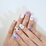Cute lilac and white press-on nails with celestial theme, 3D charms, and galaxy gradient