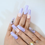 Elegant handmade nails in pastel purple with butterfly and rose charms