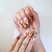 Handmade latte brown gradient press-on nails featuring gold foil edges and floral art