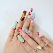 Long square acrylic nails with 3D bow and gemstone decorations by Charmeenail