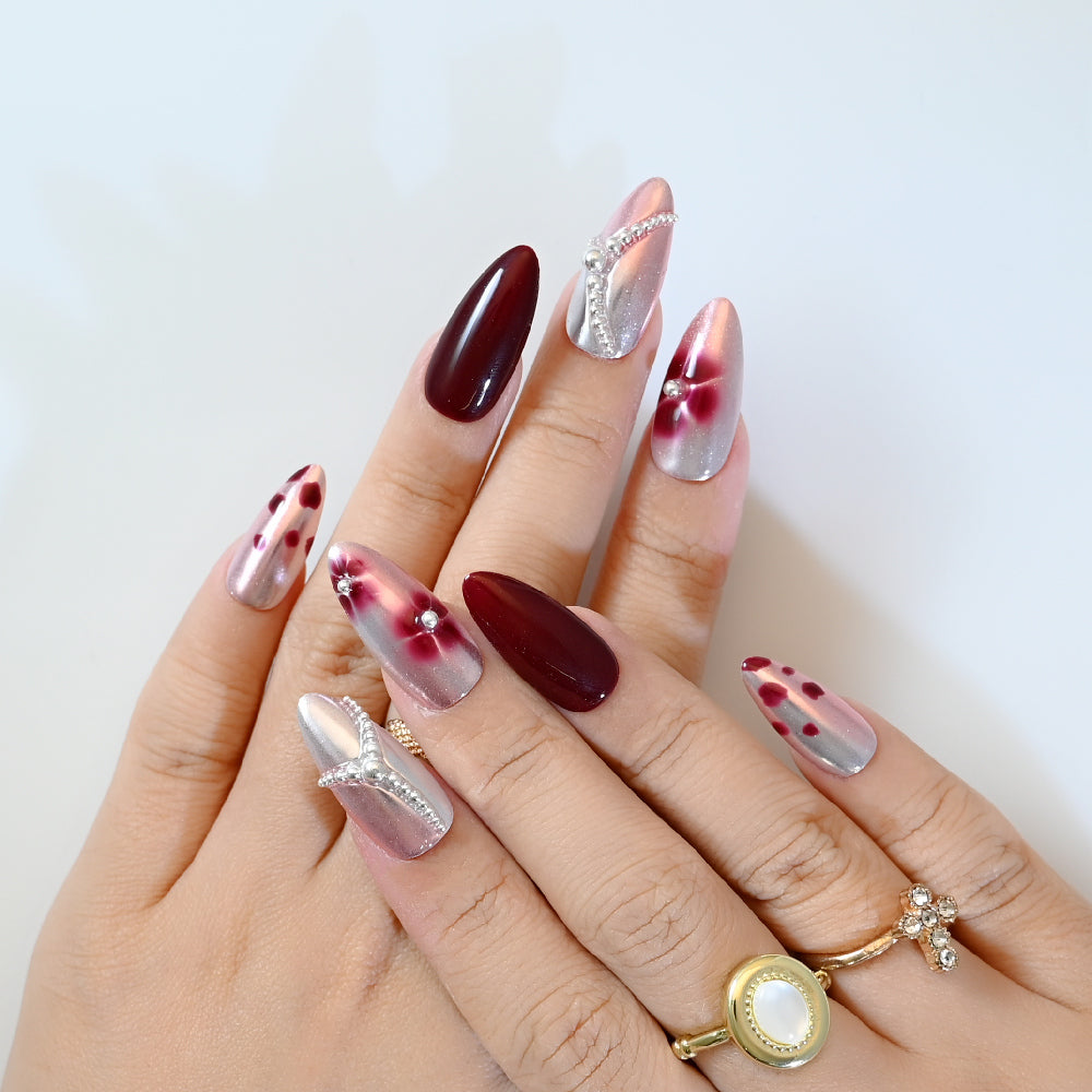 Cat eye effect press-on nails in burgundy and silver with gemstone chain design