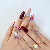 Cat eye effect press-on nails in burgundy and silver with gemstone chain design