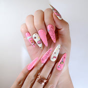 Hand-painted pink and white kawaii nails featuring LA BU BU lettering and cartoon art