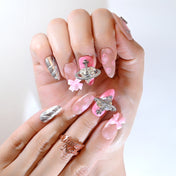 Cute pink bow and crystal planet press-on nails with galaxy-inspired design
