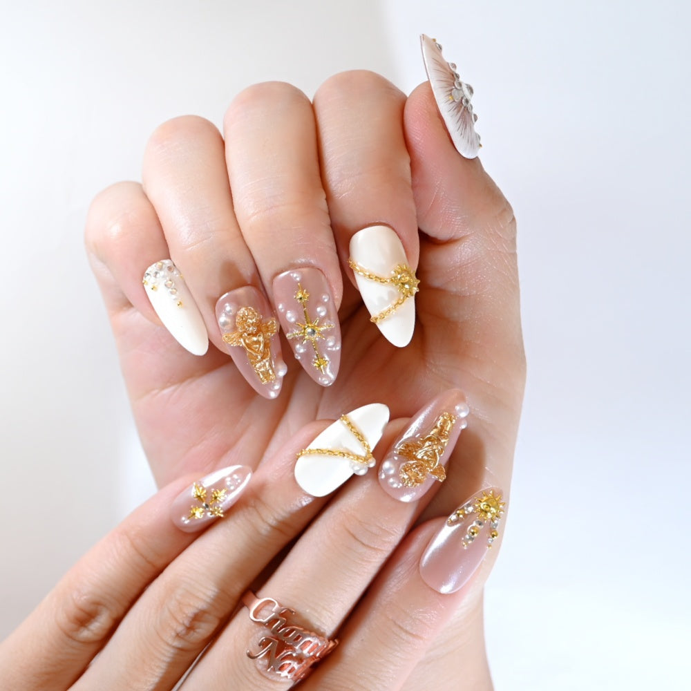 Vintage celestial press-on nails with 3D angel, sun charm, and gemstone cross
