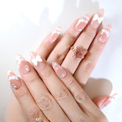 Romantic nude press-on nails with lace-like flowers and pearl details