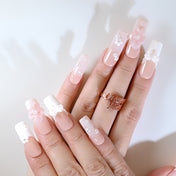 Romantic bridal press-on nails with lace-up design, pearls, and soft floral details