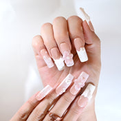 Handmade wedding nails in soft pink and white with 3D floral and pearl designs