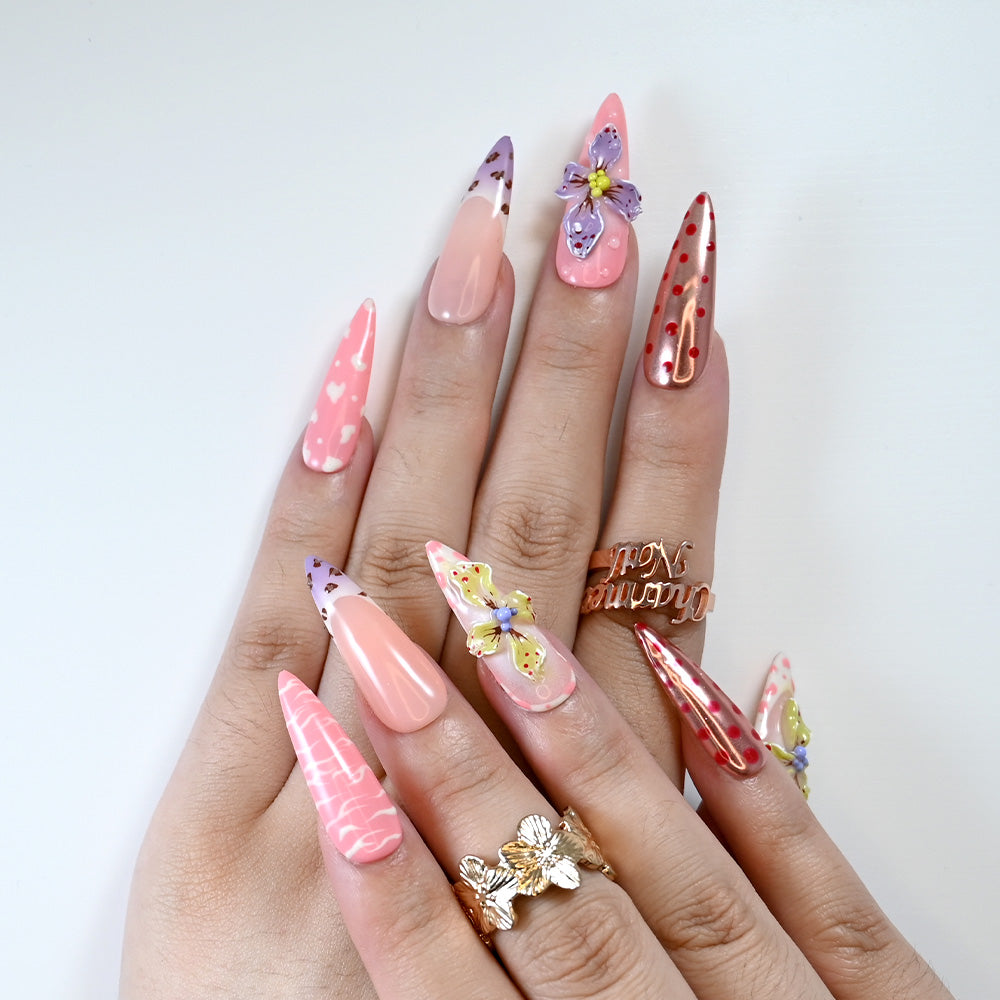 Reusable press-on nails with heart print, nude pink ombre, and 3D flowers