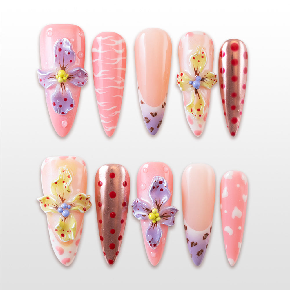 Pink press-on nails with 3D floral accents, polka dots, and animal print tips