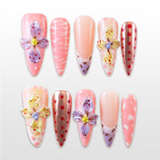 Pink press-on nails with 3D floral accents, polka dots, and animal print tips
