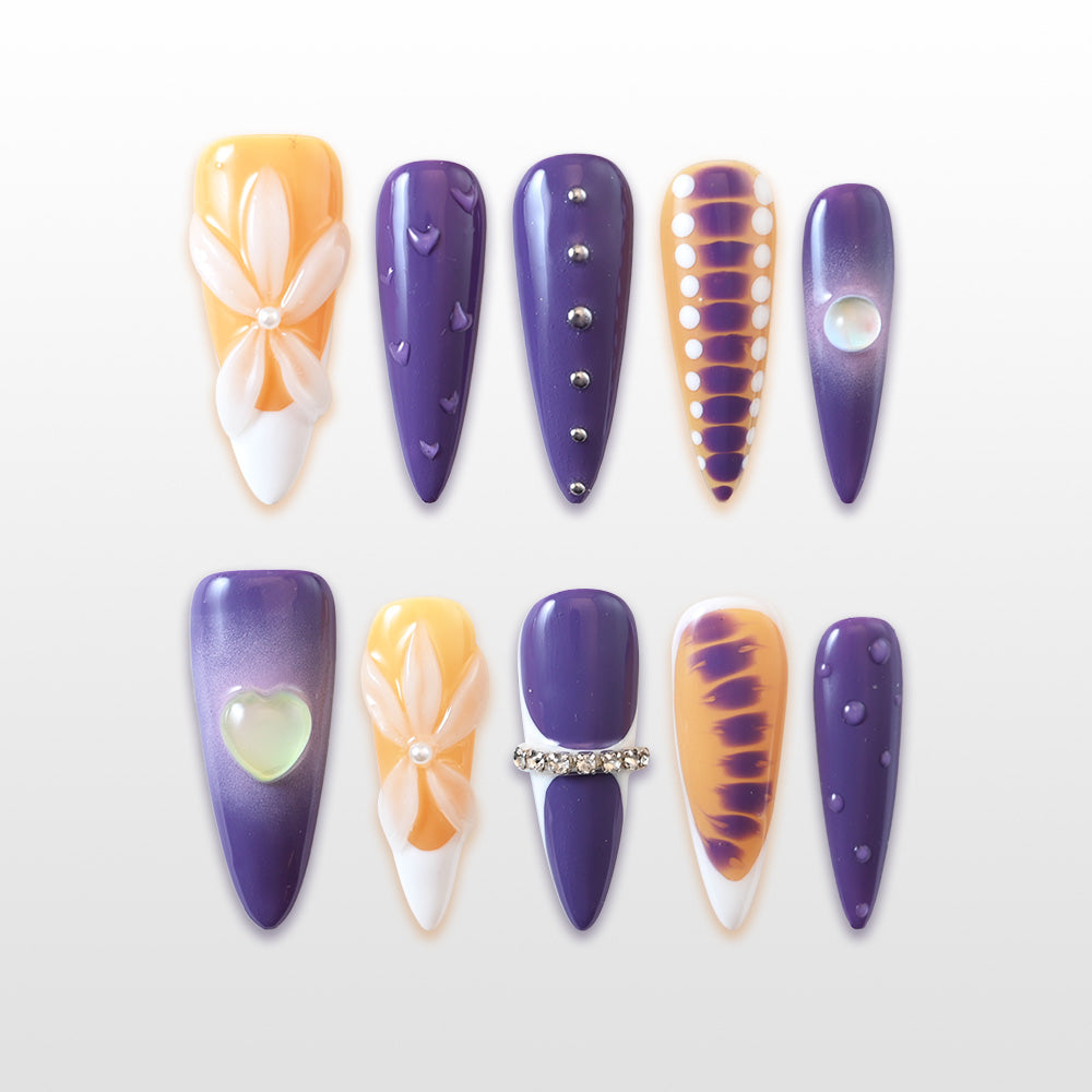 Purple and orange press-on nails with 3D white flower and rhinestone details