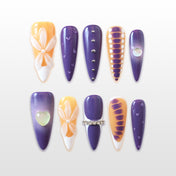 Purple and orange press-on nails with 3D white flower and rhinestone details