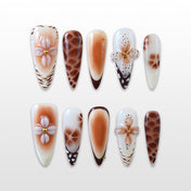 Long stiletto press-on nails with 3D flower design and brown giraffe print accents