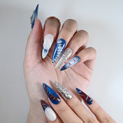 Long stiletto reusable press-on nails in deep blue, silver chrome and pearl cross accents